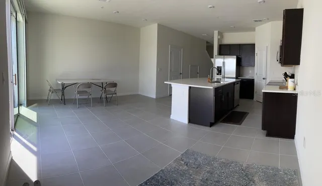 a large room with a table and chairs