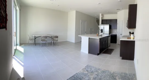 a kitchen with stainless steel appliances kitchen island granite countertop a sink and a stove