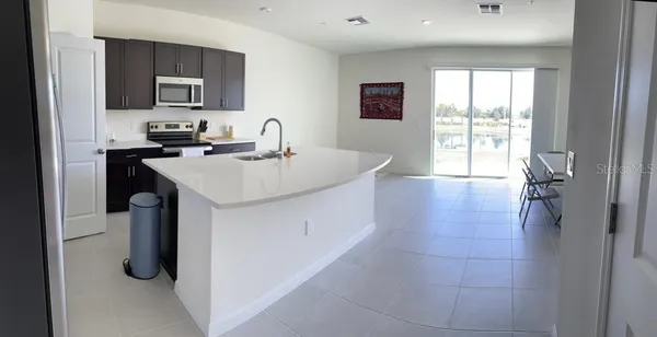 a kitchen with a sink appliances and cabinets