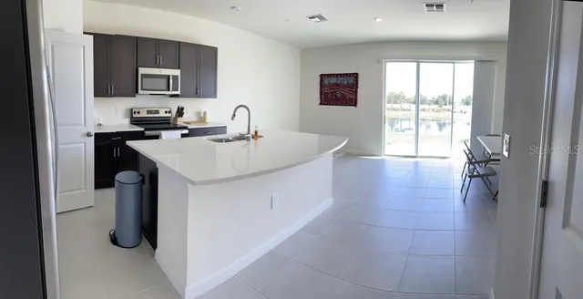 a kitchen with a sink appliances and cabinets
