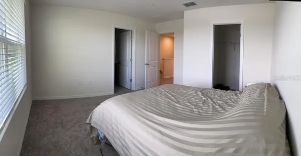 a bedroom with a bed and a window