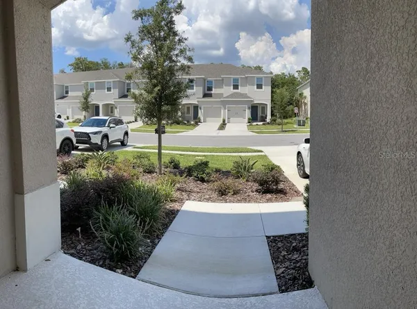 a view of a house with a yard