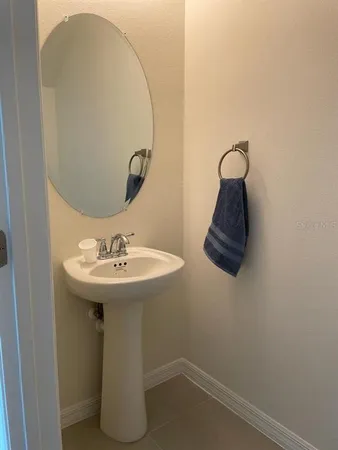 a bathroom with a sink and mirror