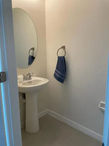 a bathroom with a sink and mirror
