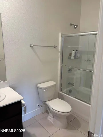 a white toilet sitting next to a bathroom sink