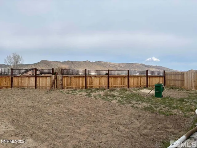 a view of large yard with a table and chairs