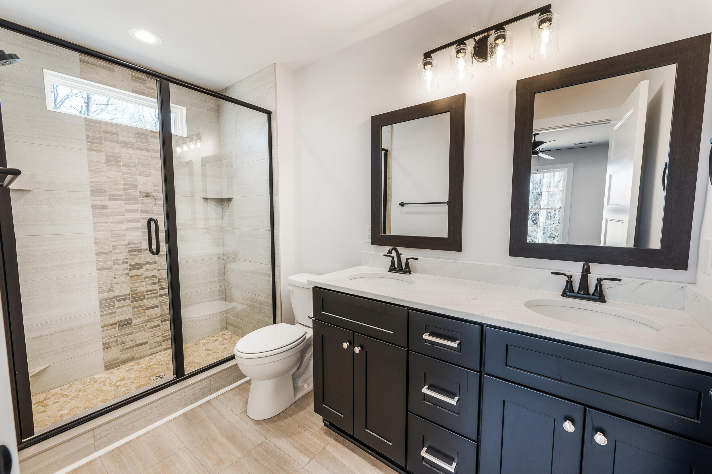 2199 Cottontown Road Forest, VA 24551 - Photo 15 of 35 a bathroom with a double vanity sink toilet mirror and shower