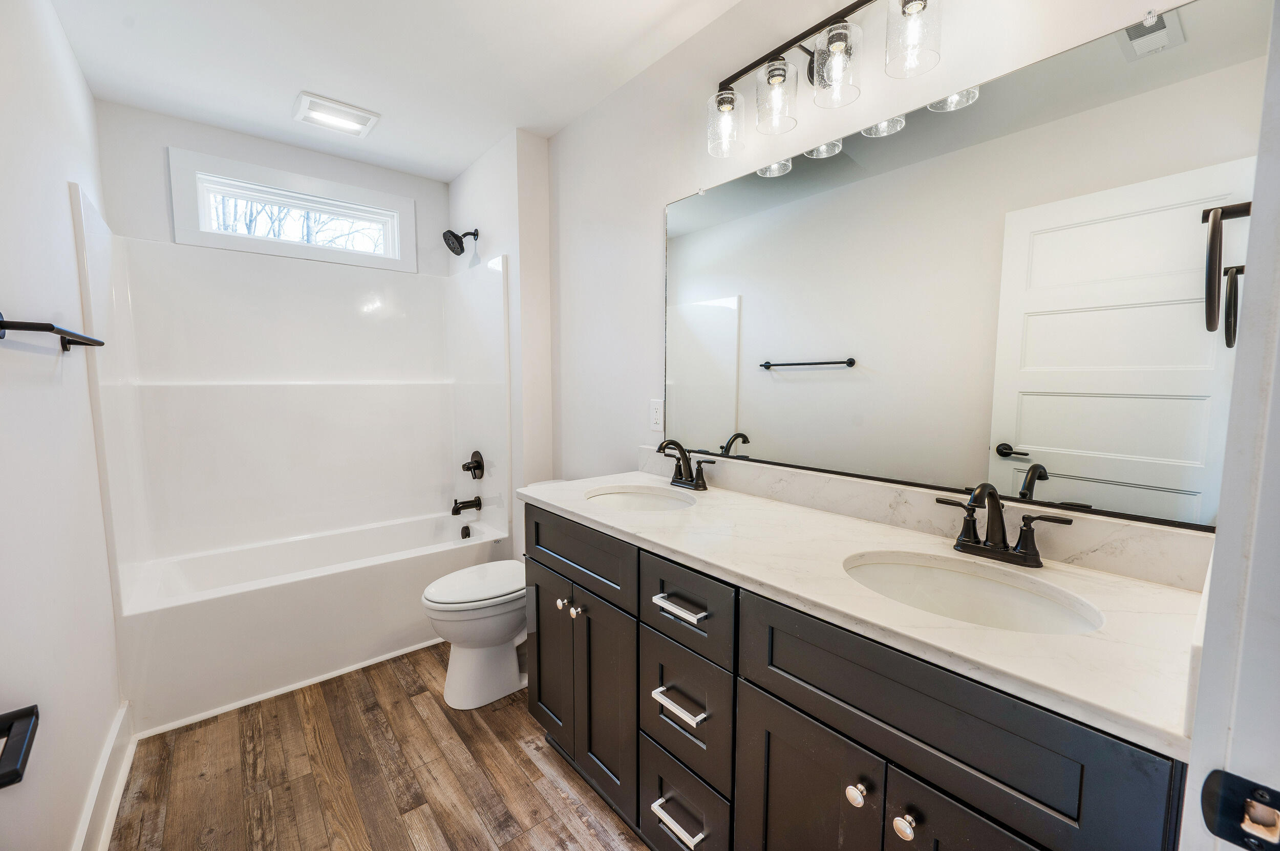 2199 Cottontown Road Forest, VA 24551 - Photo 23 of 35 a bathroom with a double vanity sink toilet mirror and bathtub