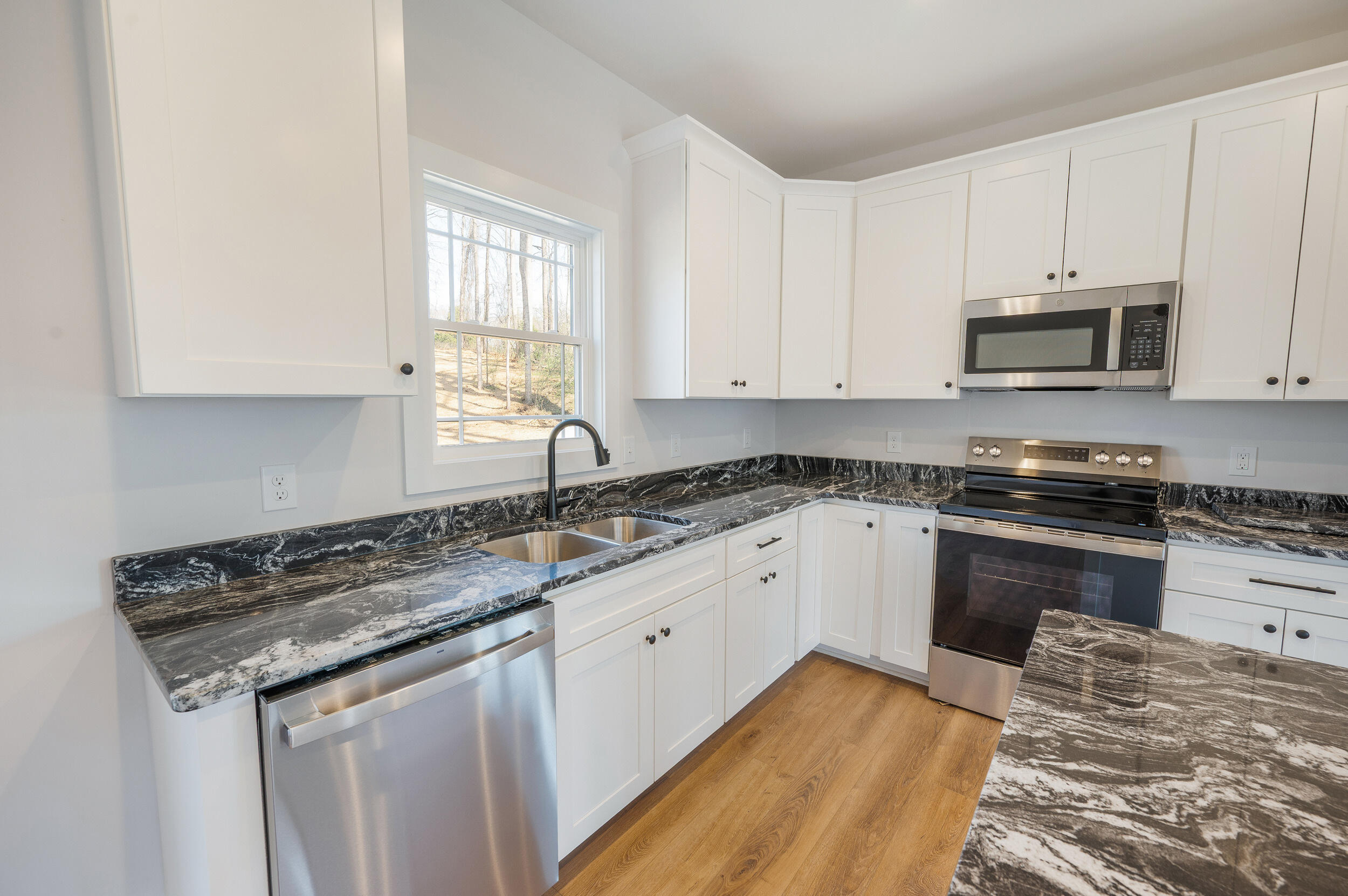 2199 Cottontown Road Forest, VA 24551 - Photo 8 of 35 a kitchen with granite countertop a sink a stove and cabinets