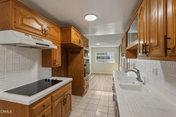 a kitchen with stainless steel appliances granite countertop a sink stove and cabinets