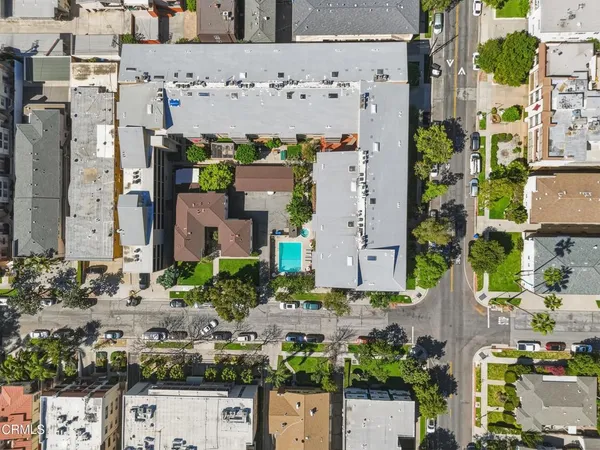 an aerial view of residential building and trees around