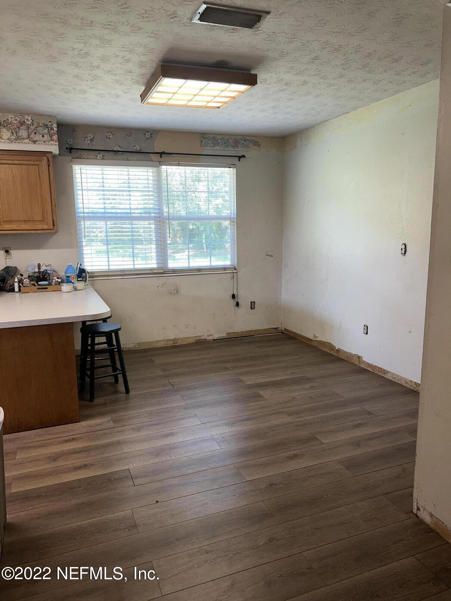 120 Kelly Smith School Road Palatka, FL 32177 - Photo 17 of 17 a room with a wooden floor and furniture