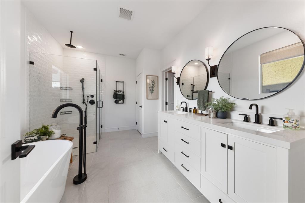 1340 Cartona Road Fate, TX 75087 - Photo 14 of 32 a bathroom with a double vanity sink double mirror and bathtub