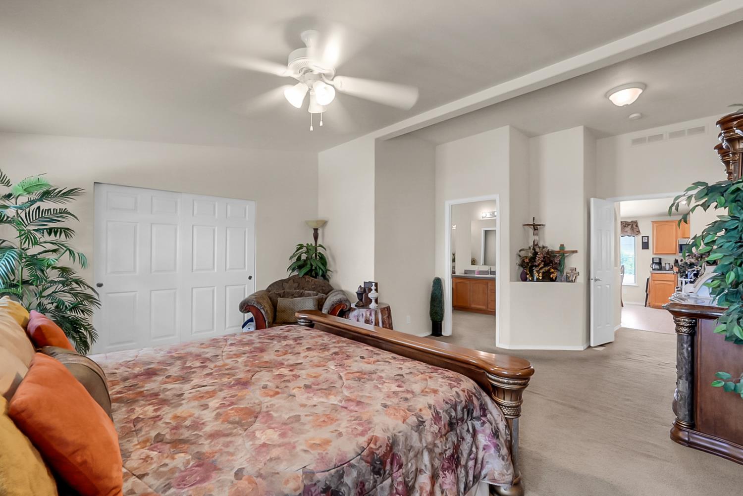 19814 West Grant Line Road Tracy, CA 95391 - Photo 15 of 57 a bedroom with a large bed and a potted plant