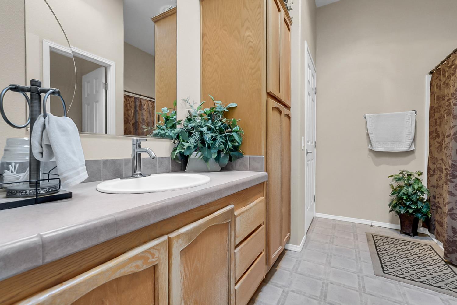 19814 West Grant Line Road Tracy, CA 95391 - Photo 19 of 57 a bathroom with a sink and a mirror