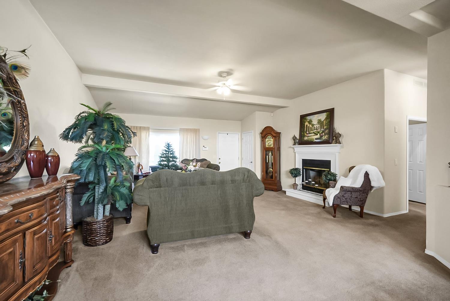 19814 West Grant Line Road Tracy, CA 95391 - Photo 4 of 57 a living room with furniture and a fireplace