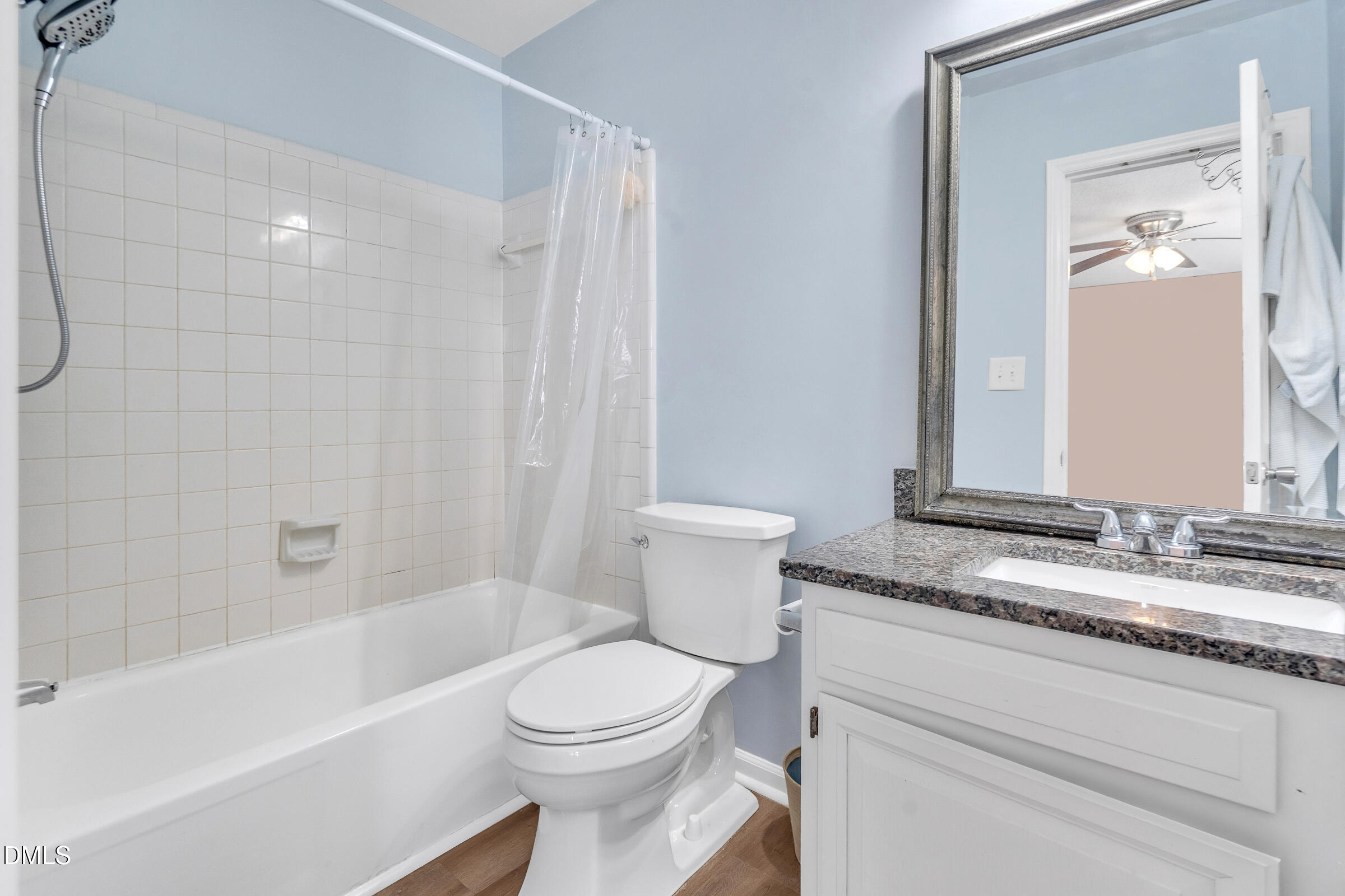 6410 English Oaks Drive Raleigh, NC 27615 - Photo 11 of 19 a bathroom with a granite countertop sink a toilet and a bathtub