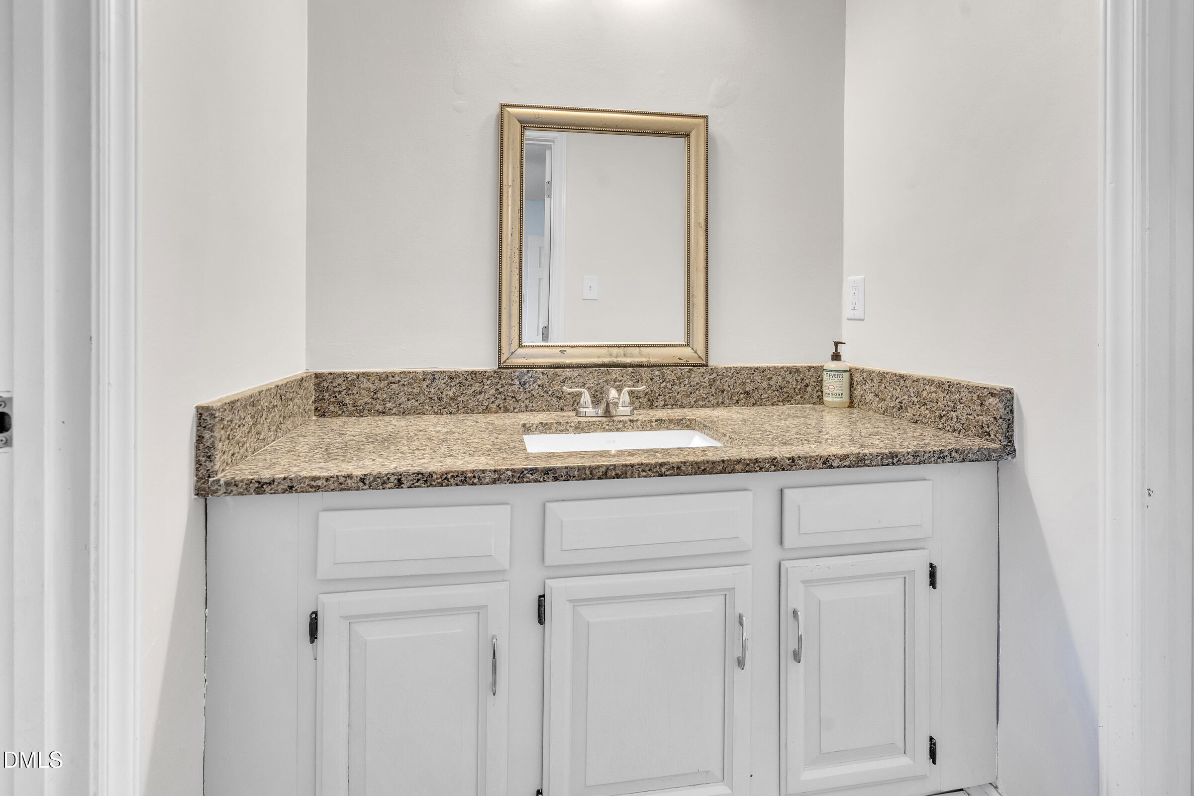 6410 English Oaks Drive Raleigh, NC 27615 - Photo 13 of 19 a bathroom with a granite countertop sink and a mirror