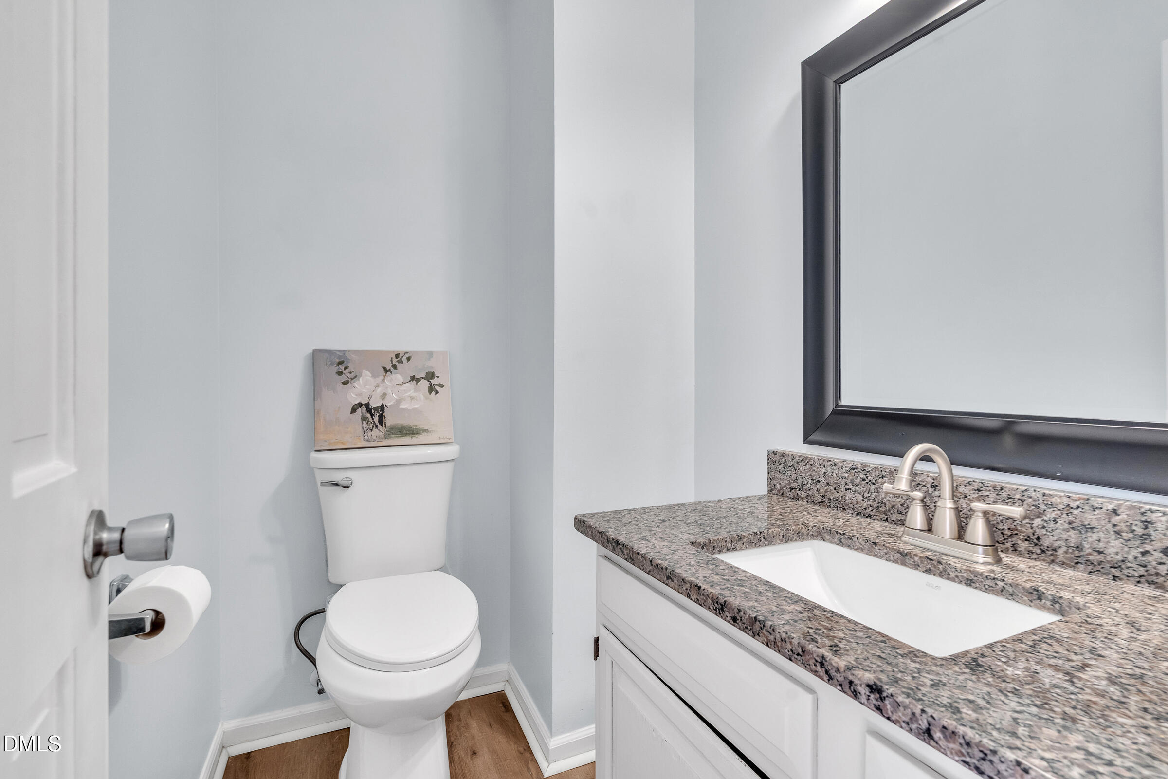 6410 English Oaks Drive Raleigh, NC 27615 - Photo 8 of 19 a bathroom with a granite countertop toilet sink and mirror