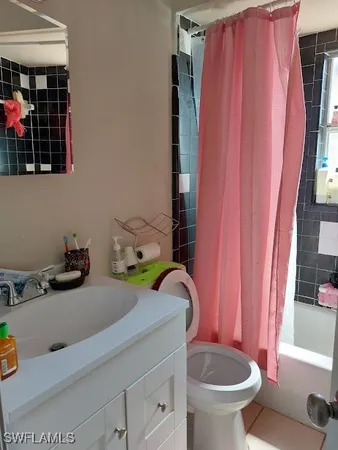 a white toilet sitting next to a small bathroom