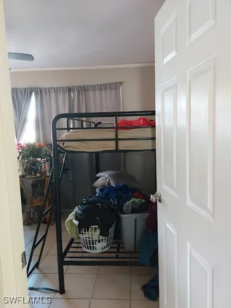 a bed sitting in a bedroom next to a window
