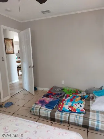 a bedroom with a bed and ceiling fan