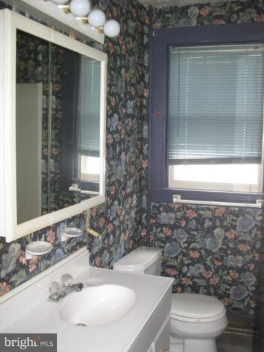 720 Wampler Road Middle River, MD 21220 - Photo 10 of 23 a bathroom with a toilet a sink and mirror