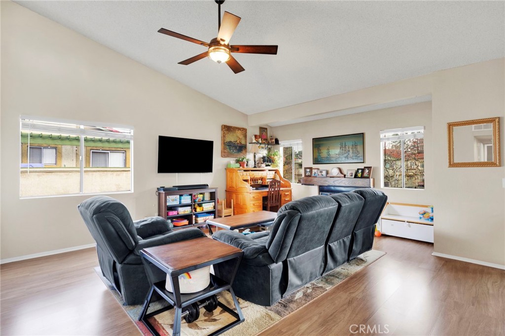 8423 Western Trail Place, Unit H Rancho Cucamonga, CA 91730 - Photo 11 of 42 a living room with furniture a flat screen tv and a window