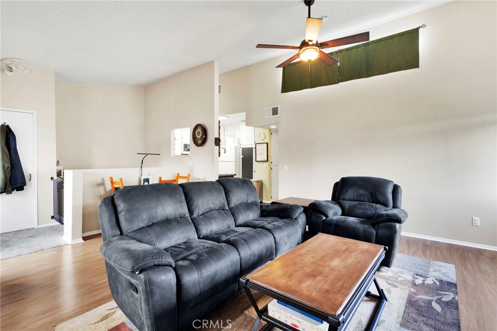 8423 Western Trail Place, Unit H Rancho Cucamonga, CA 91730 - Photo 12 of 42 a living room with furniture and a flat screen tv