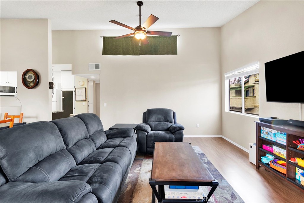 8423 Western Trail Place, Unit H Rancho Cucamonga, CA 91730 - Photo 13 of 42 a living room with furniture and a flat screen tv