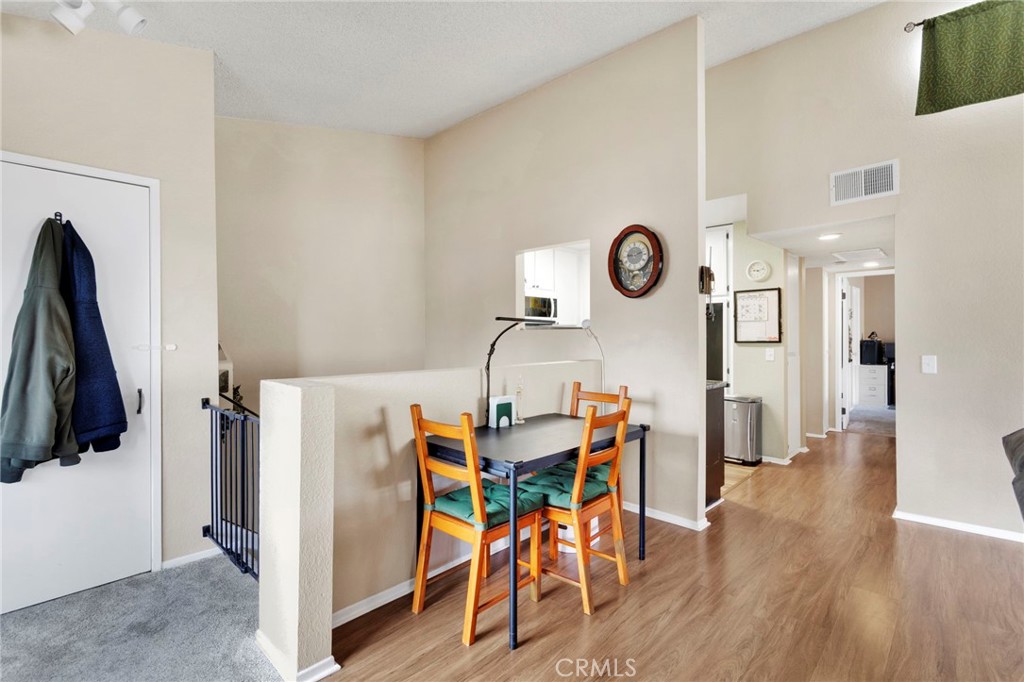 8423 Western Trail Place, Unit H Rancho Cucamonga, CA 91730 - Photo 14 of 42 a view of a dining area with furniture and wooden floor