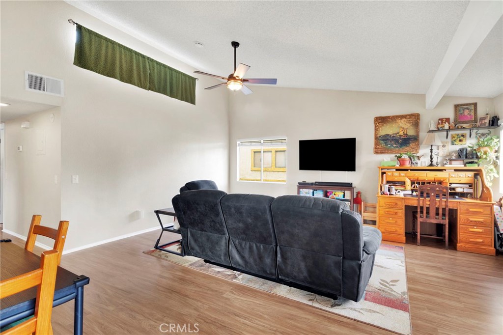 8423 Western Trail Place, Unit H Rancho Cucamonga, CA 91730 - Photo 15 of 42 a living room with furniture and a flat screen tv