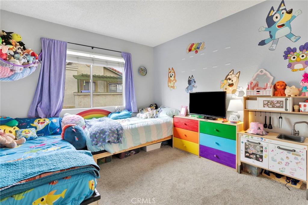 8423 Western Trail Place, Unit H Rancho Cucamonga, CA 91730 - Photo 20 of 42 a bedroom with baby bed and window