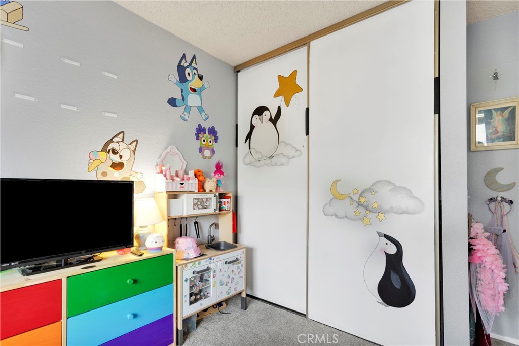 8423 Western Trail Place, Unit H Rancho Cucamonga, CA 91730 - Photo 22 of 42 a view of living room with furniture and flat screen tv