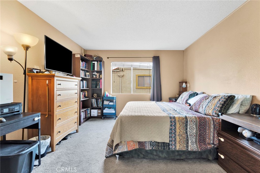 8423 Western Trail Place, Unit H Rancho Cucamonga, CA 91730 - Photo 24 of 42 a bed room with a bed and a television