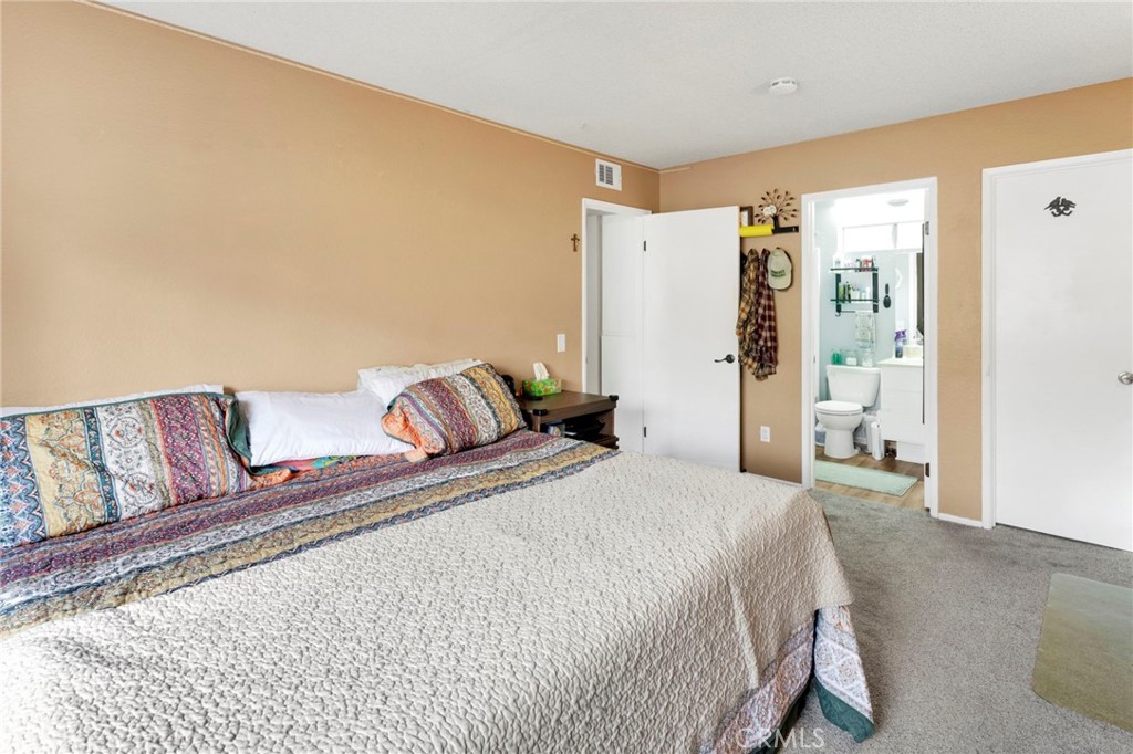 8423 Western Trail Place, Unit H Rancho Cucamonga, CA 91730 - Photo 26 of 42 a bedroom with a large bed and a couch