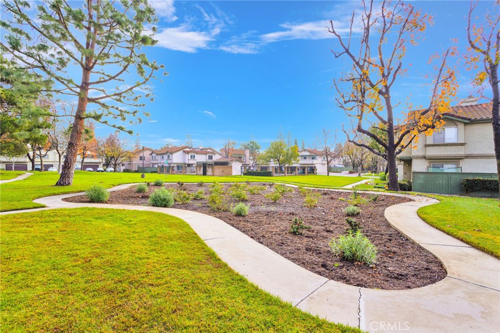 8423 Western Trail Place, Unit H Rancho Cucamonga, CA 91730 - Photo 30 of 42 a view of a swimming pool with lawn chairs and a big yard