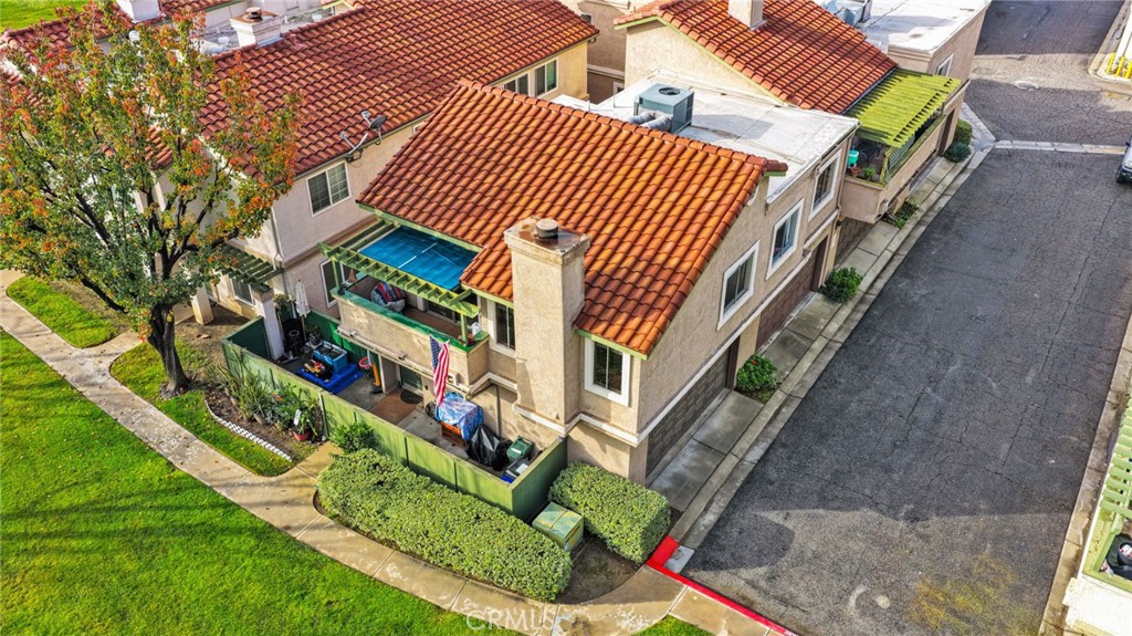 8423 Western Trail Place, Unit H Rancho Cucamonga, CA 91730 - Photo 34 of 42 a front view of a house with a garden