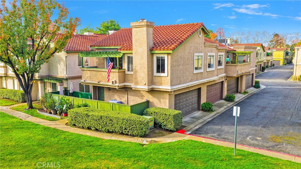 8423 Western Trail Place, Unit H Rancho Cucamonga, CA 91730 - Photo 36 of 42 a front view of a house with a yard
