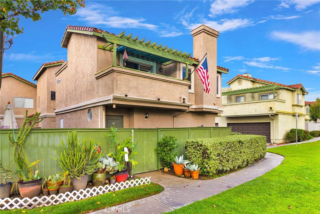 8423 Western Trail Place, Unit H Rancho Cucamonga, CA 91730 - Photo 5 of 42 a front view of a house with a yard and potted plants