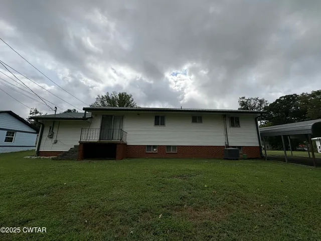 a view of a yard with a large tree
