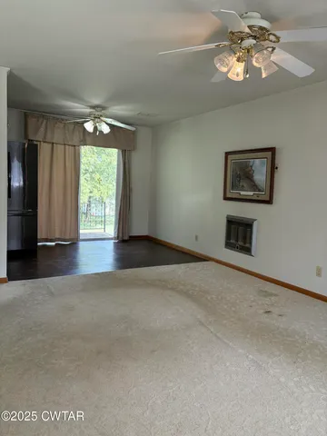 a view of livingroom with furniture chandelier and window