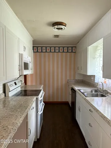 a metallic refrigerator freezer sitting in a kitchen