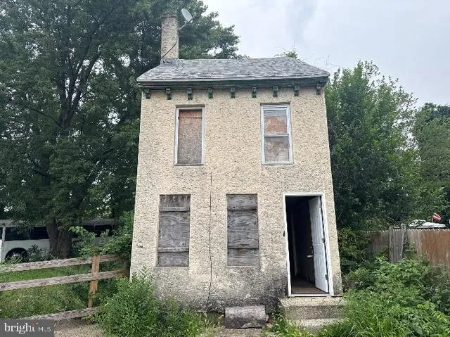 a front view of a house with plants
