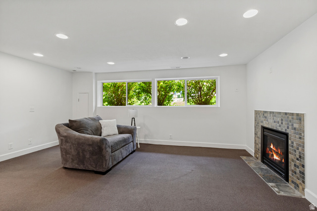 9706 Raintree Drive Sandy, UT 84092 - Photo 26 of 42 Recessed lighting, white walls, multiple windows, carpet flooring, and a fireplace with tile surround