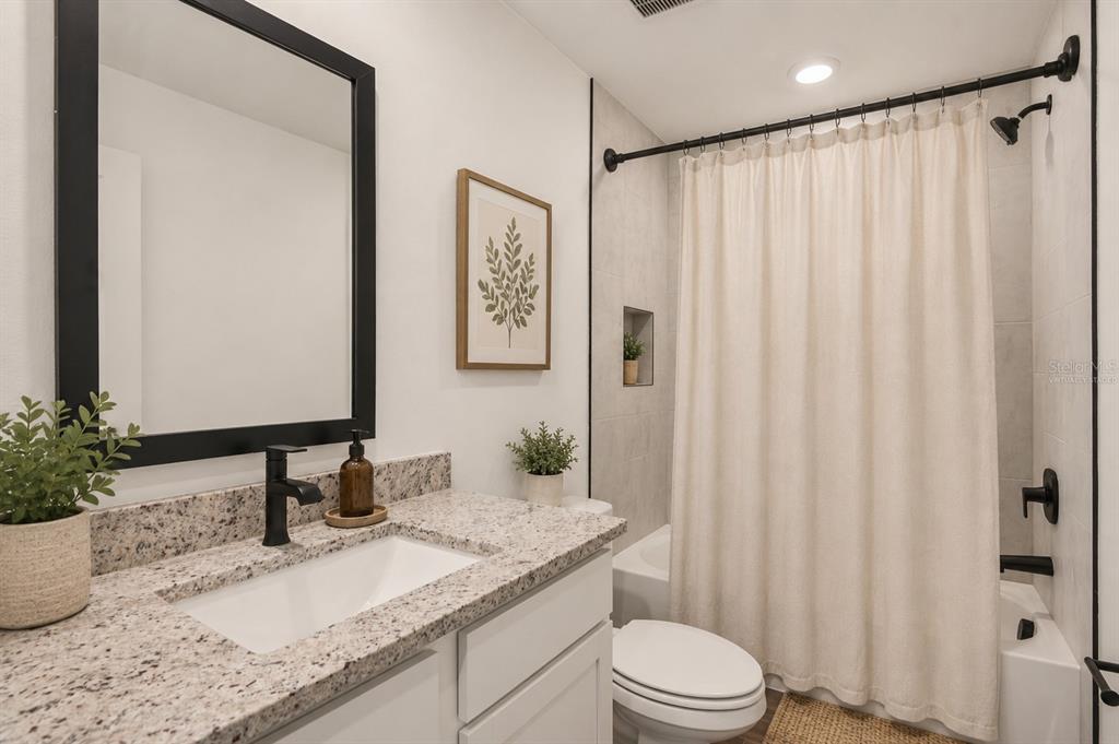 8338 Coral Street Spring Hill, FL 34606 - Photo 13 of 13 a bathroom with a granite countertop sink and a mirror