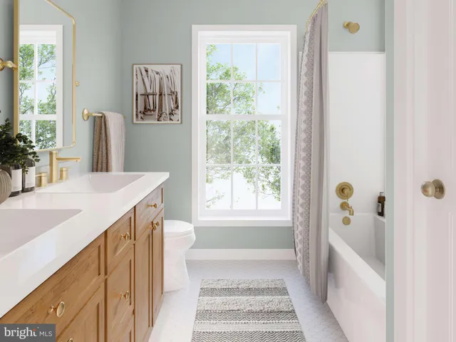 a bathroom with a sink a window and a bathtub