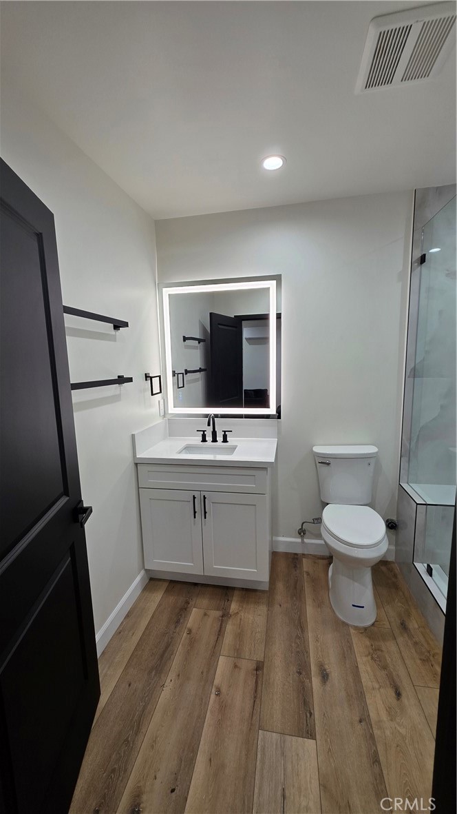 7047 1/2 Nestle Avenue Reseda, CA 91335 - Photo 4 of 7 a room with a toilet sink and mirror