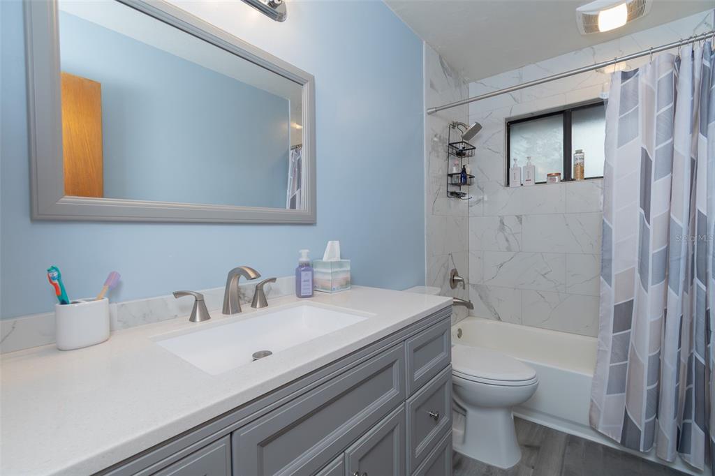 2300 Southwest 43rd Street, Unit K5 Gainesville, FL 32607 - Photo 11 of 18 a bathroom with a sink a toilet and shower