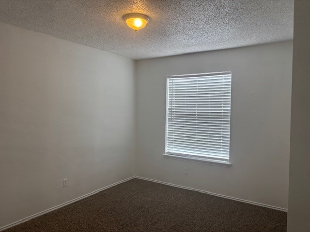 6702 Everhart Road, Unit H103 Corpus Christi, TX 78413 - Photo 11 of 14 an empty room with a window